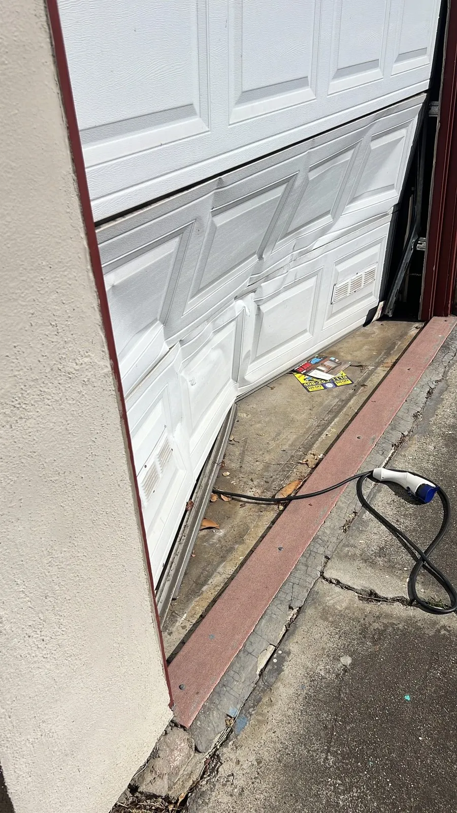 A dented lower panel on a sectional garage door