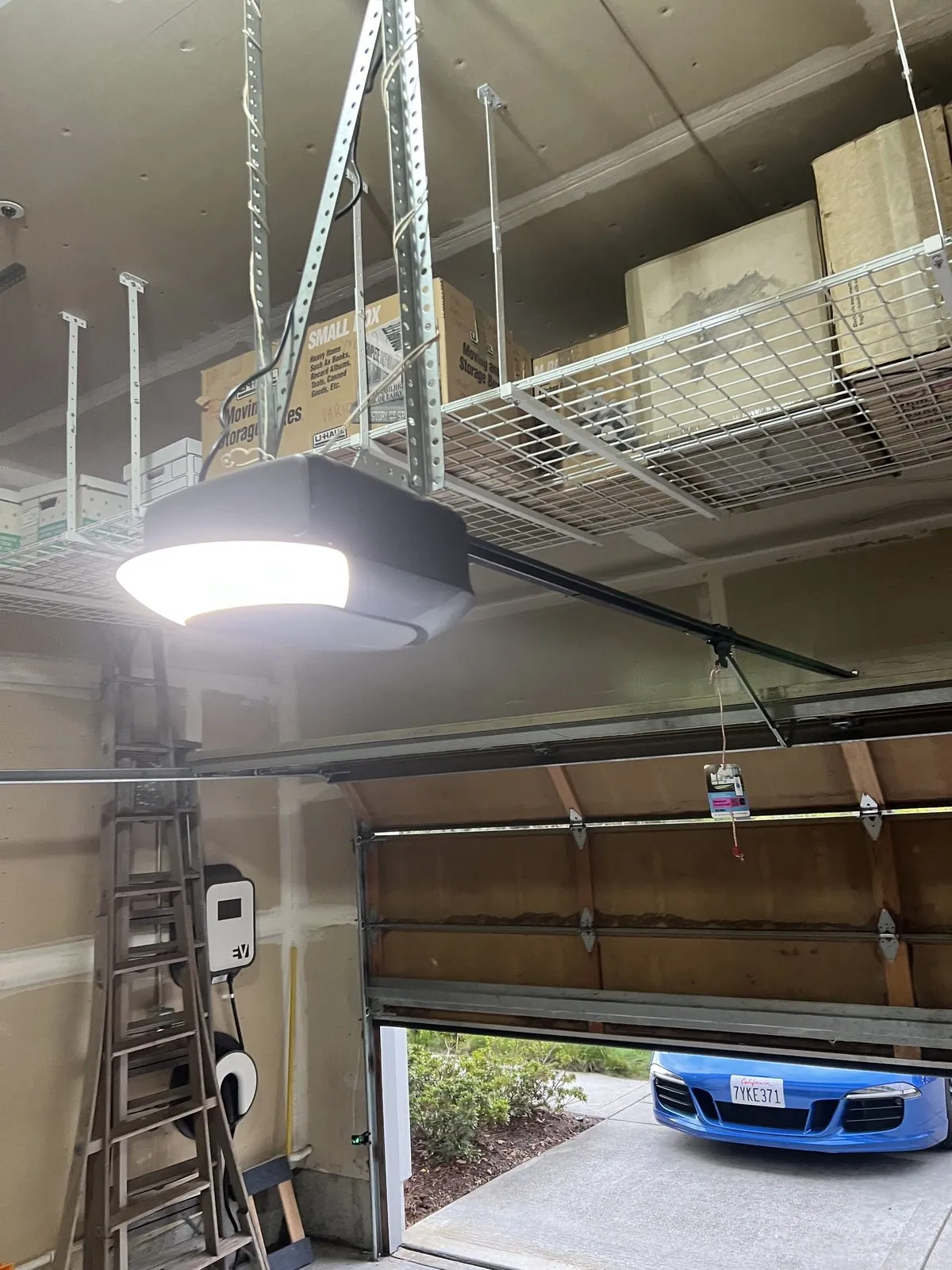 A newly installed garage door opener unit on the ceiling